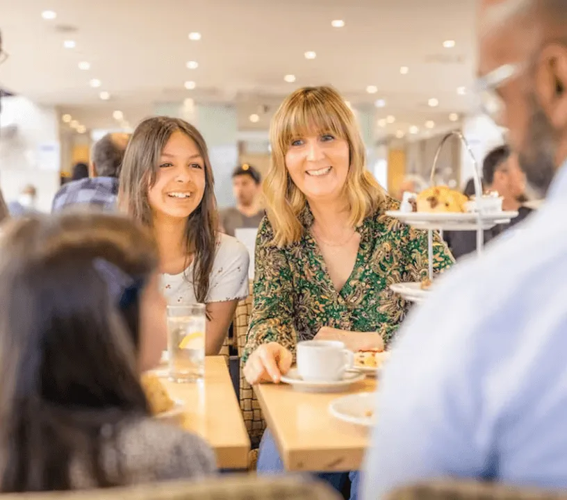 Passengers enjoying afternoon tea aboard a river cruise