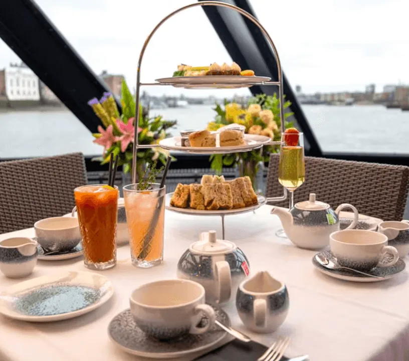 Tiered cakes and sandwiches on a Thames afternoon tea cruise