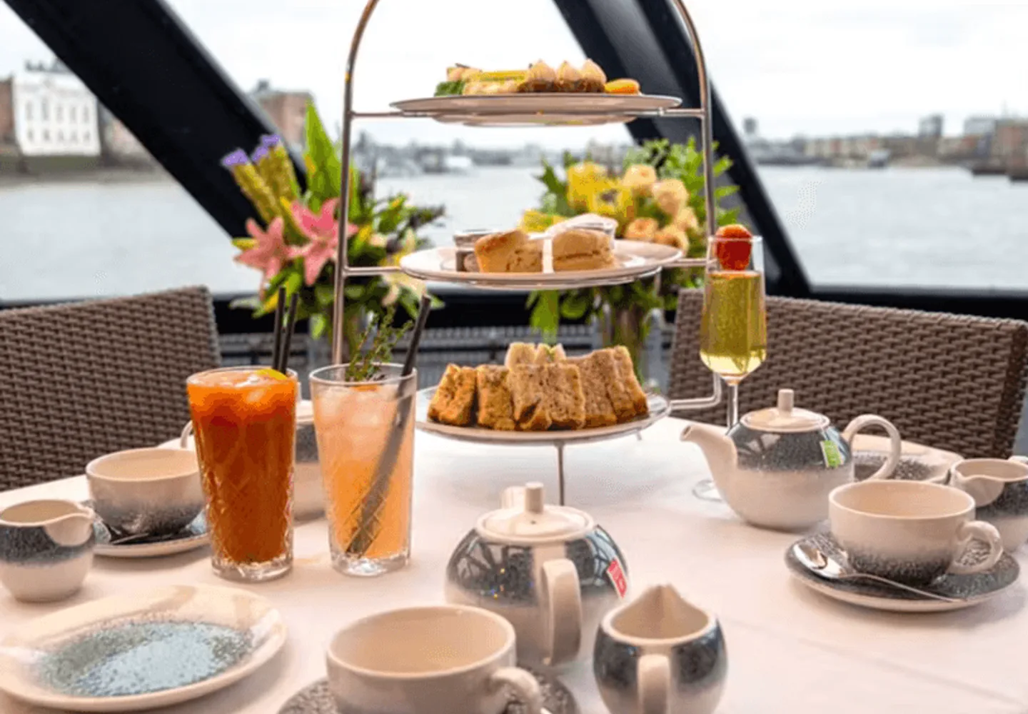 Tiered cakes and sandwiches on a Thames afternoon tea cruise