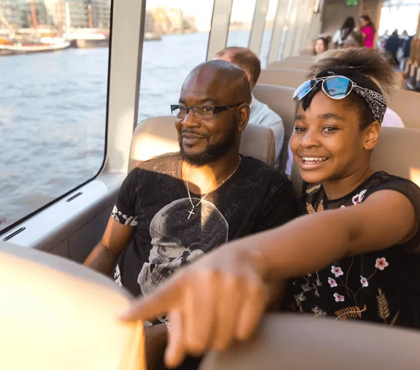 Passengers seated aboard a Thames river bus